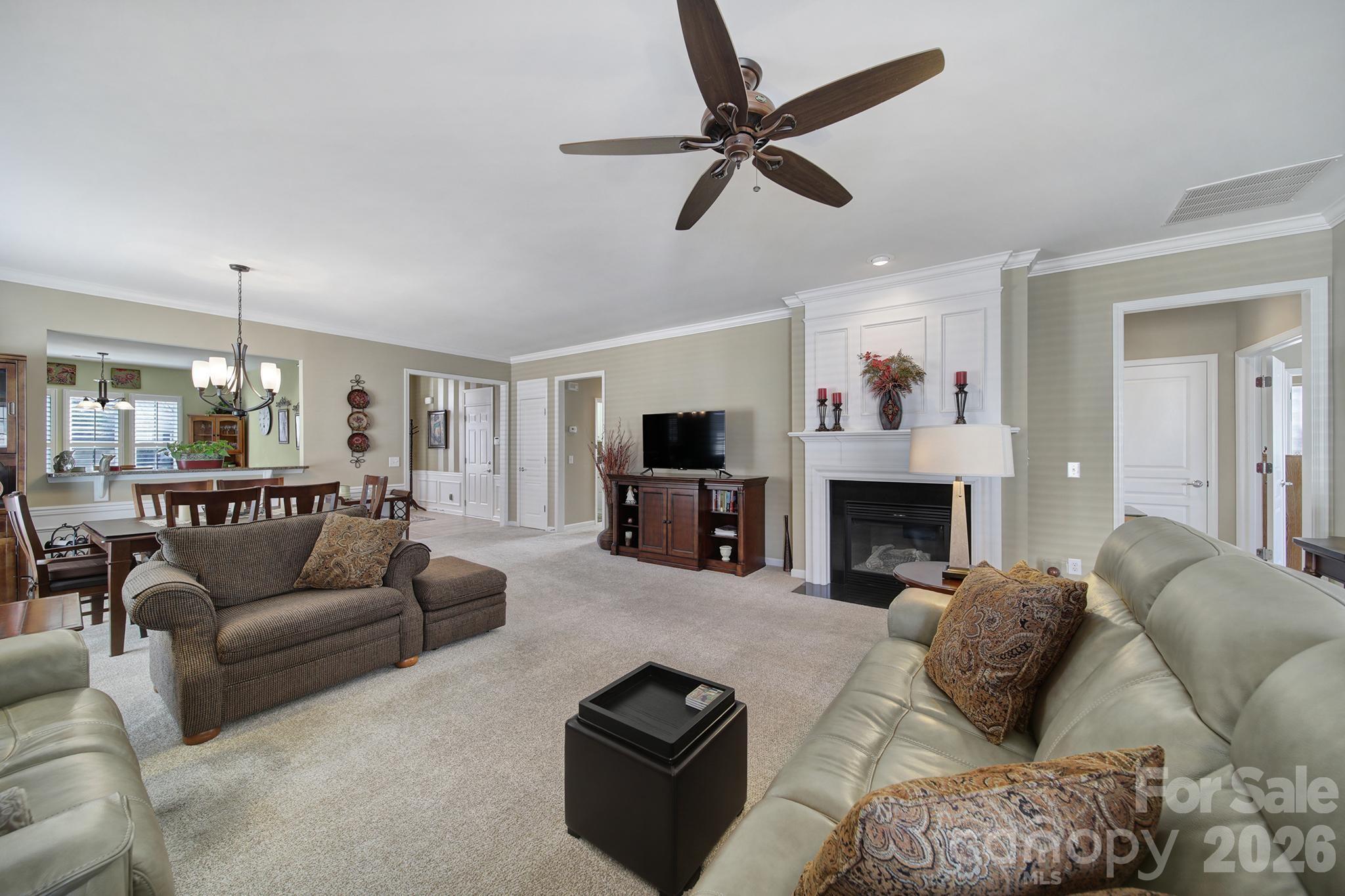 52083 Longspur Lane Fort Mill, SC 29707 - Photo 13 of 48 a living room with furniture a fireplace and a flat screen tv