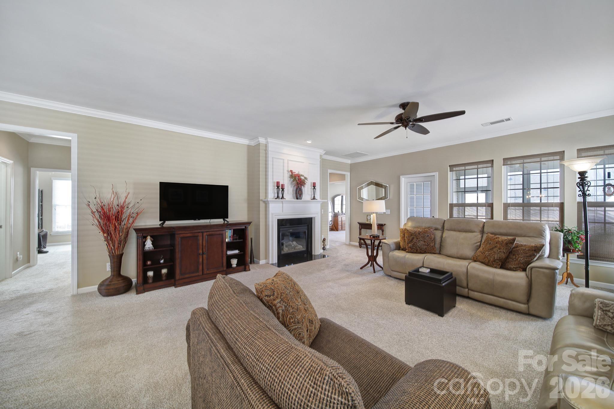 52083 Longspur Lane Fort Mill, SC 29707 - Photo 14 of 48 a living room with furniture a flat screen tv and a fireplace