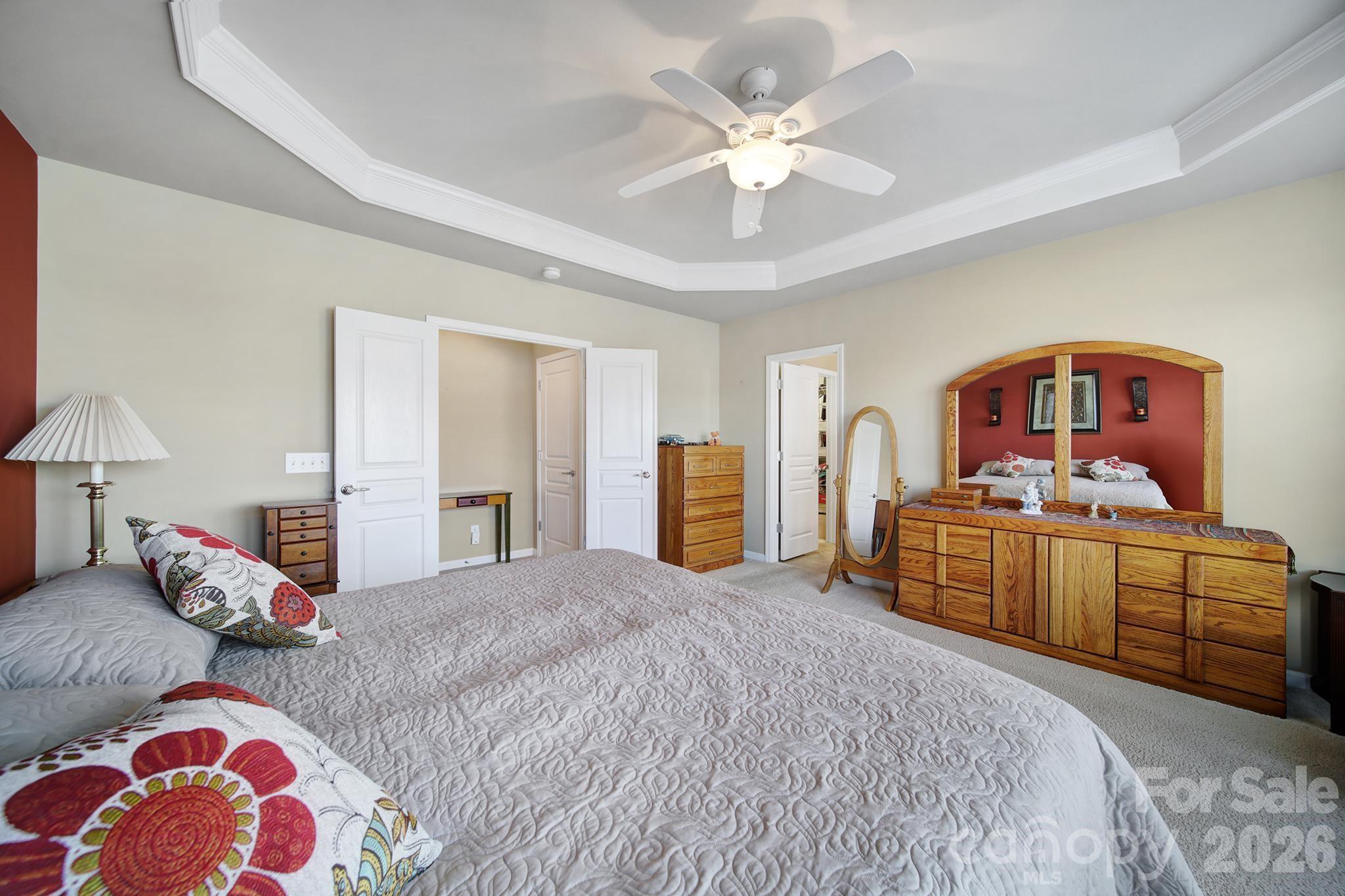 52083 Longspur Lane Fort Mill, SC 29707 - Photo 17 of 48 a bedroom with a bed and a chandelier