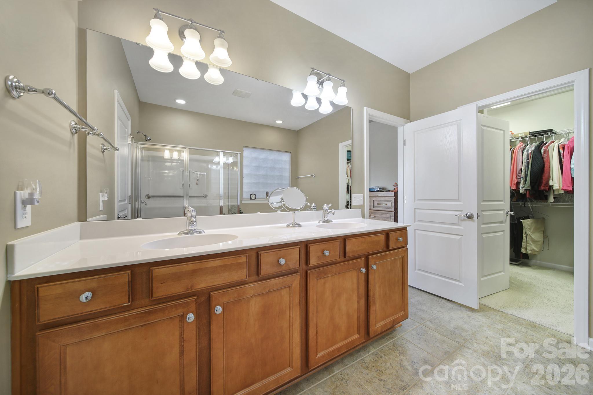 52083 Longspur Lane Fort Mill, SC 29707 - Photo 18 of 48 a bathroom with a double vanity sink and a mirror