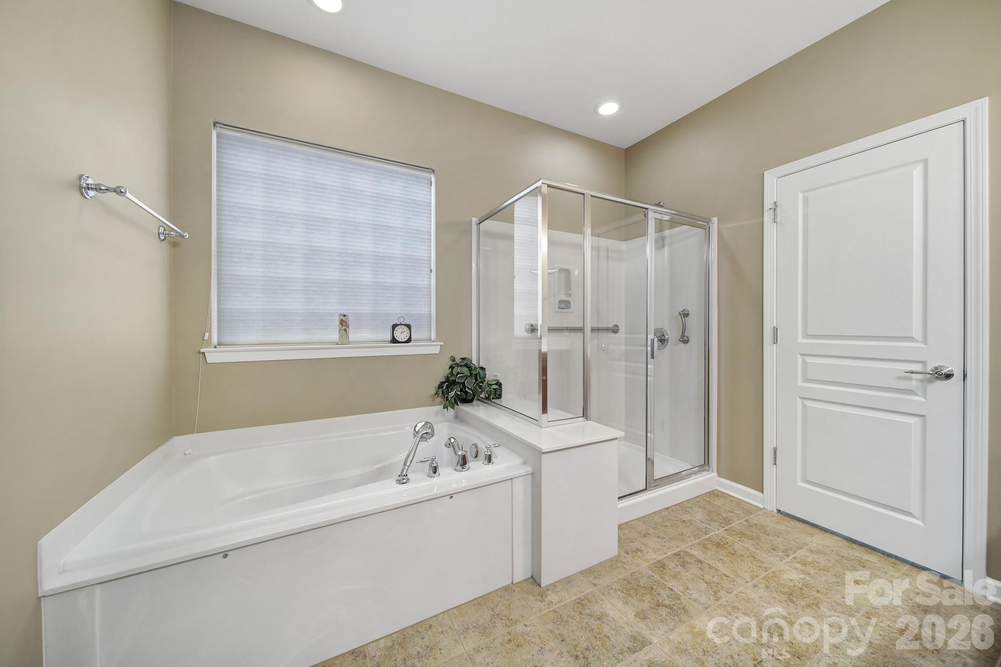 52083 Longspur Lane Fort Mill, SC 29707 - Photo 19 of 48 a bathroom with a bathtub and a shower