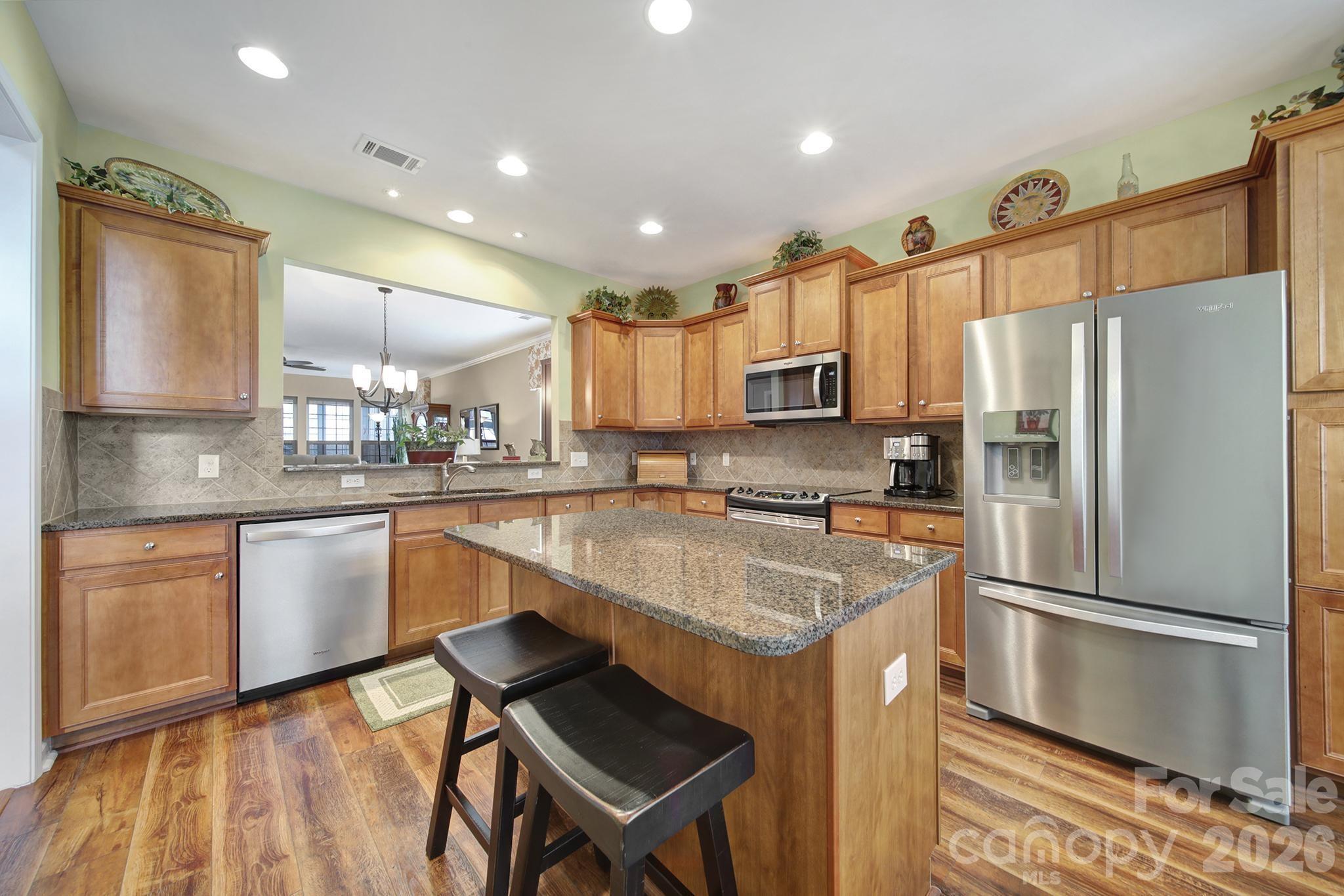 52083 Longspur Lane Fort Mill, SC 29707 - Photo 5 of 48 a kitchen with a refrigerator a sink and cabinets