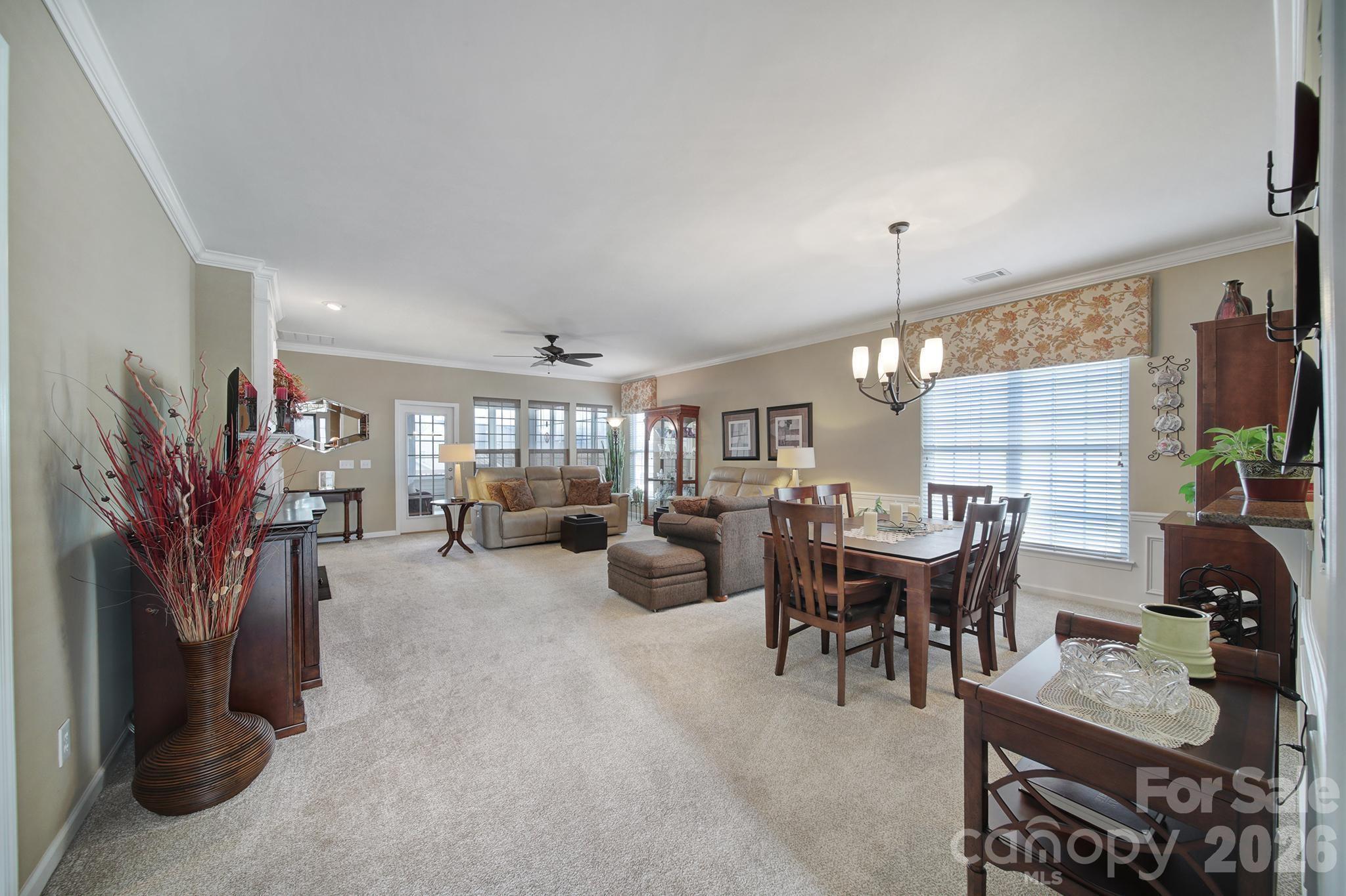 52083 Longspur Lane Fort Mill, SC 29707 - Photo 9 of 48 a living room with furniture a chandelier and a large window