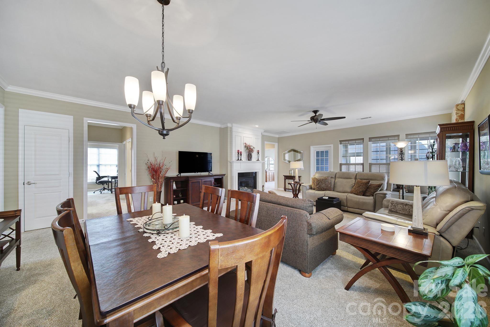 52083 Longspur Lane Fort Mill, SC 29707 - Photo 10 of 48 a view of a dining room with furniture a chandelier and wooden floor
