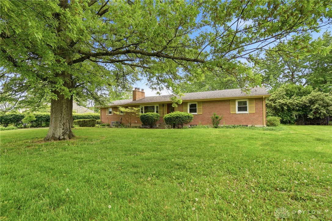 6119 Flemington Road Dayton, OH 45459 - Photo 73 of 76 This classic brick ranch sits on a lush, green lawn, offering timeless charm and comfortable living.