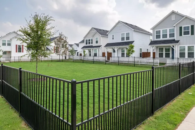 a view of a house with a wooden deck and a yard