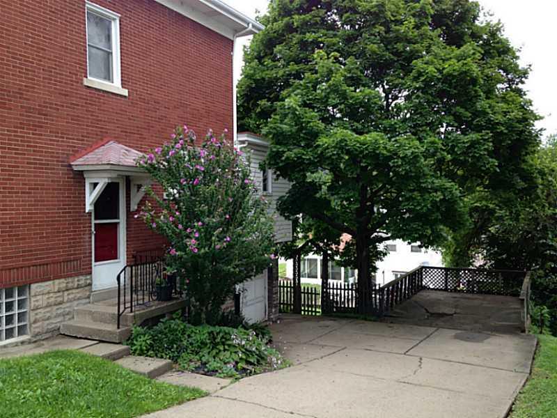 1634 Chartiers Avenue McKees Rocks, PA 15136 - Photo 23 of 23 Other. Side of house with driveway and garage door.