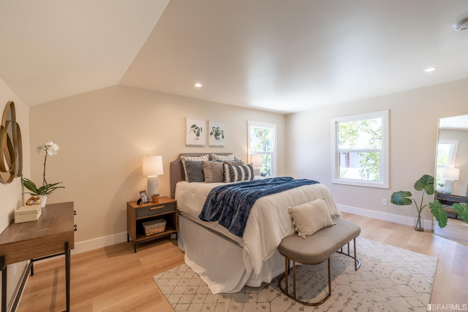 951 University Avenue Berkeley, CA 94710 - Photo 23 of 34 a spacious bedroom with a bed and a chair