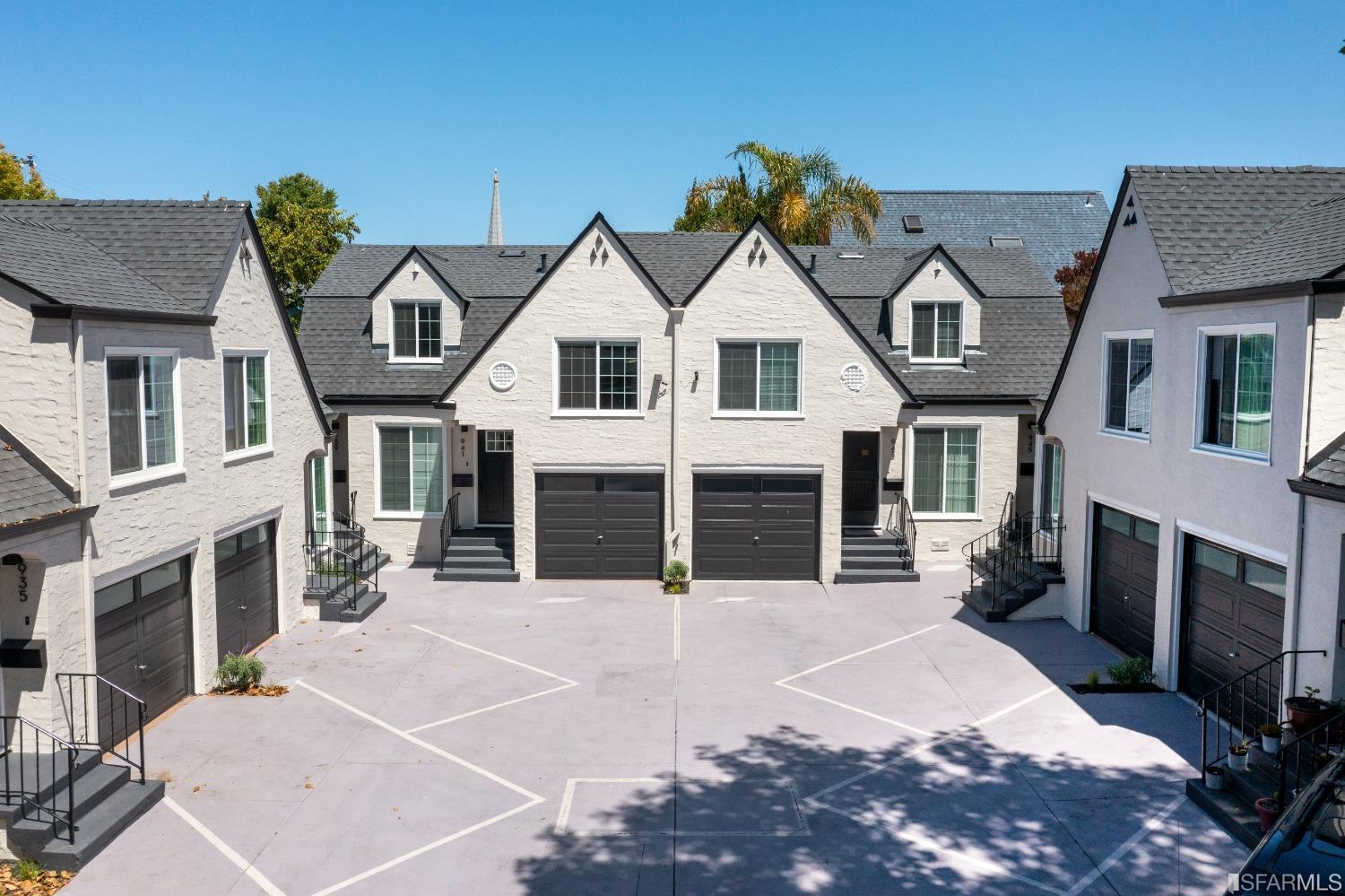 951 University Avenue Berkeley, CA 94710 - Photo 3 of 34 a view of a white house with large windows and a yard