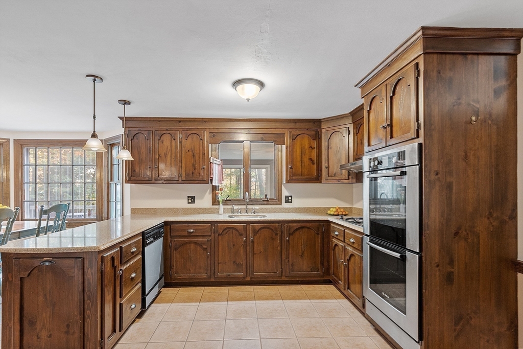 426 River Road Andover, MA 01810 - Photo 11 of 42 a kitchen with a sink stove and cabinets