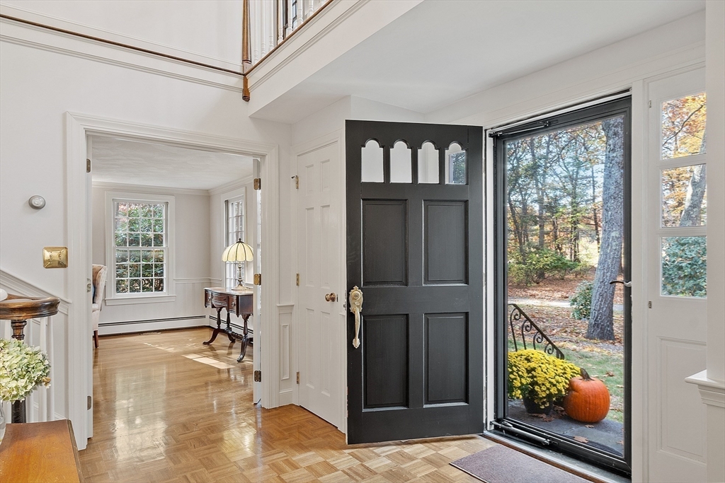 426 River Road Andover, MA 01810 - Photo 7 of 42 a view of an entryway with wooden floor and a livingroom view