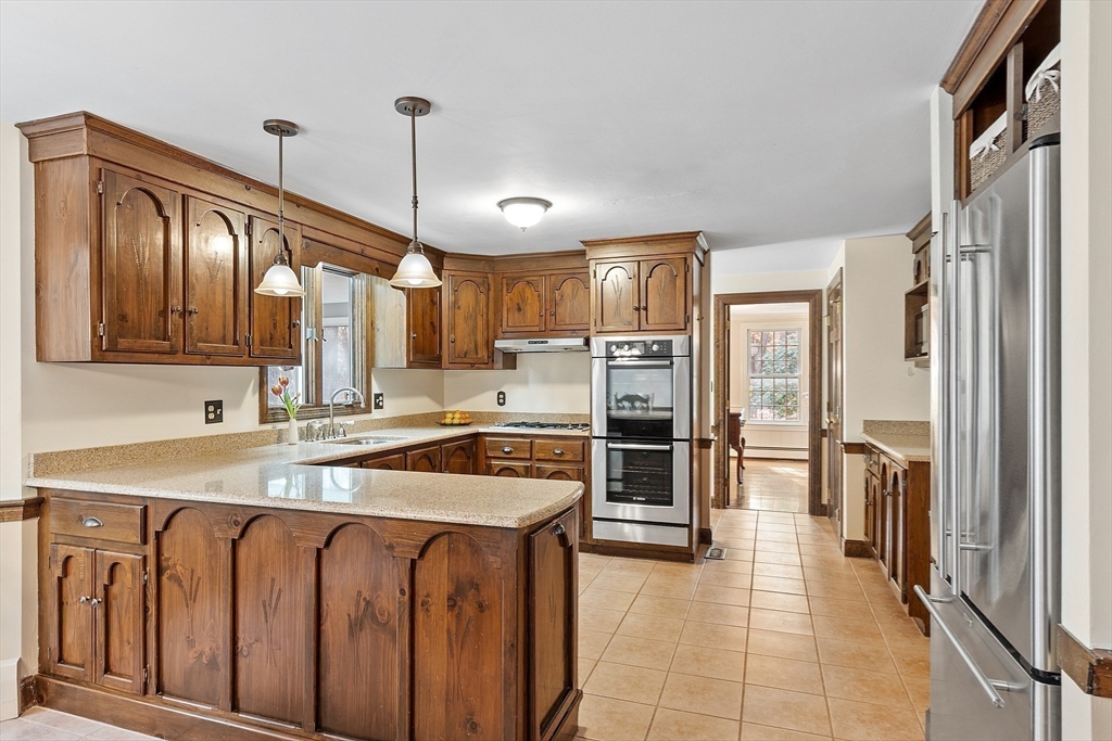 426 River Road Andover, MA 01810 - Photo 10 of 42 a kitchen that has a stove a refrigerator and a sink