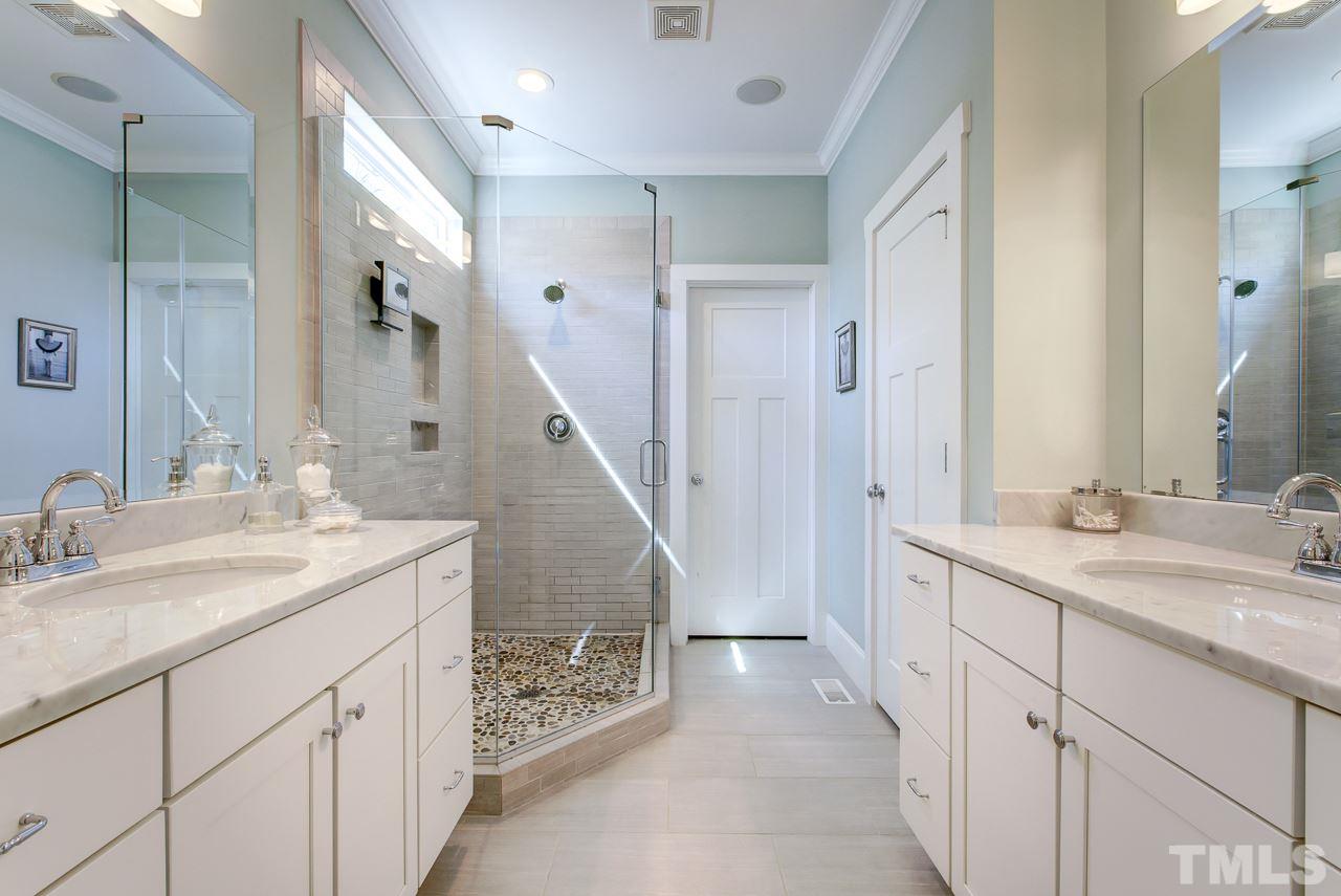 1711 Center Road Raleigh, NC 27608 - Photo 11 of 25 a spacious bathroom with a double vanity sink and a mirror