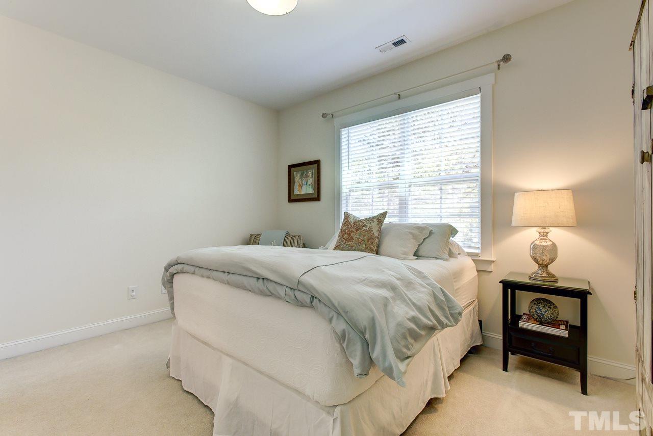 1711 Center Road Raleigh, NC 27608 - Photo 13 of 25 a bedroom with a bed and a window