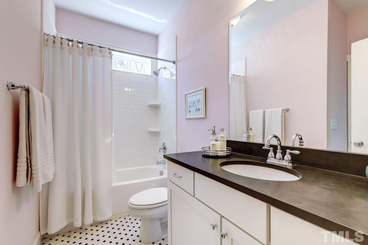 1711 Center Road Raleigh, NC 27608 - Photo 14 of 25 a bathroom with a granite countertop sink toilet and shower