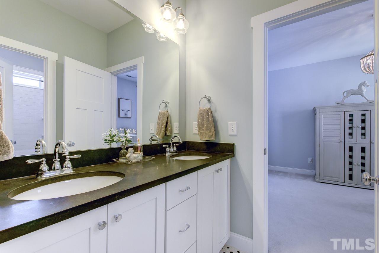 1711 Center Road Raleigh, NC 27608 - Photo 16 of 25 a bathroom with double sink and a mirror