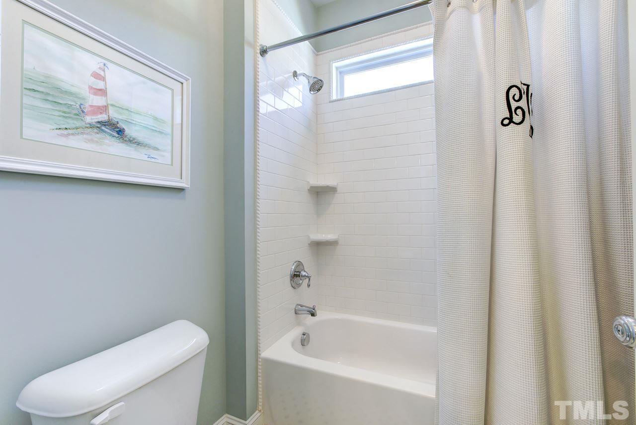 1711 Center Road Raleigh, NC 27608 - Photo 17 of 25 a white toilet sitting next to a bath tub