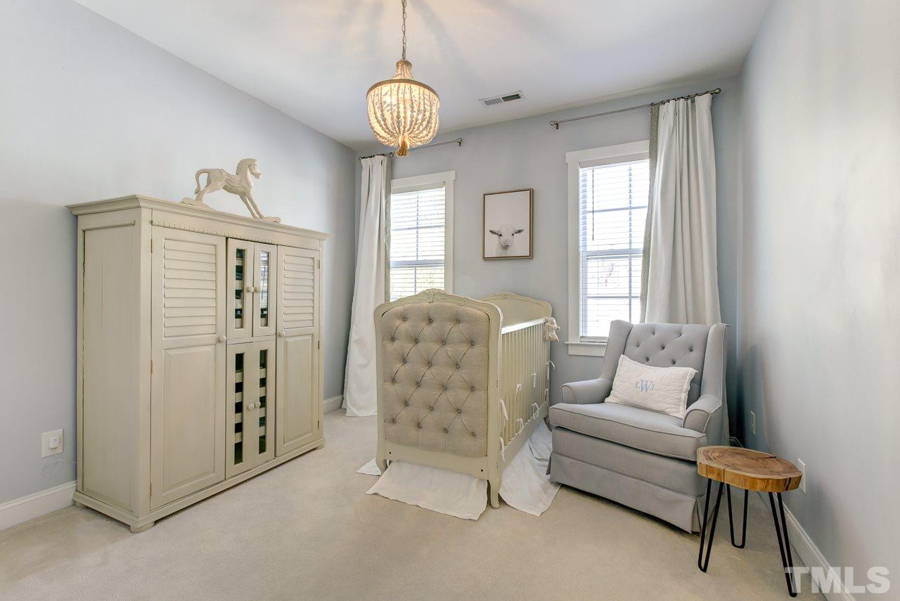 1711 Center Road Raleigh, NC 27608 - Photo 18 of 25 a living room with furniture and a chandelier