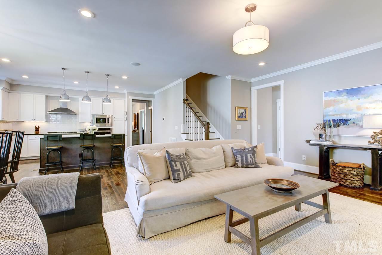 1711 Center Road Raleigh, NC 27608 - Photo 4 of 25 a living room with furniture kitchen view and a chandelier
