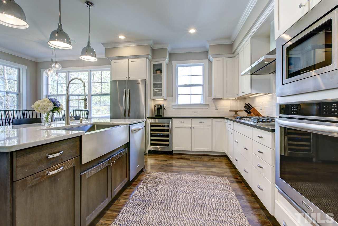1711 Center Road Raleigh, NC 27608 - Photo 6 of 25 a kitchen with stainless steel appliances granite countertop a stove a sink and a refrigerator