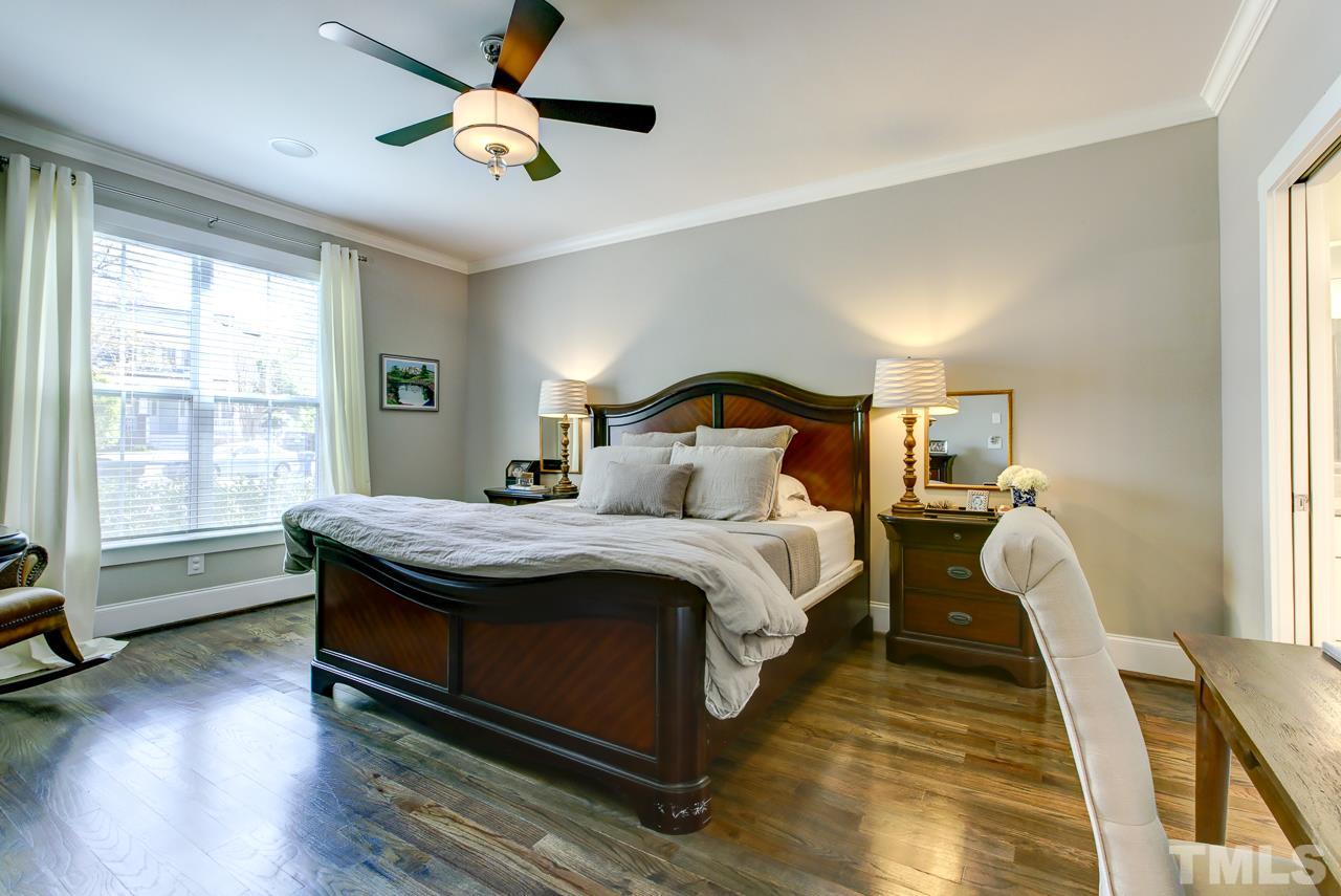 1711 Center Road Raleigh, NC 27608 - Photo 9 of 25 a bedroom with a bed flat screen tv and a large window