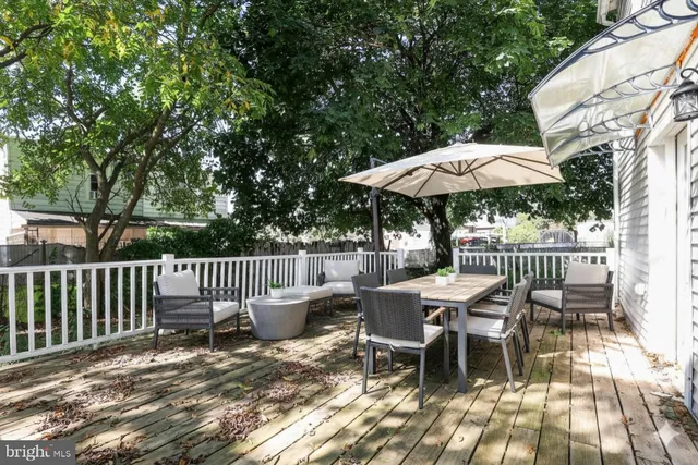 a view of a chairs and table under an umbrella