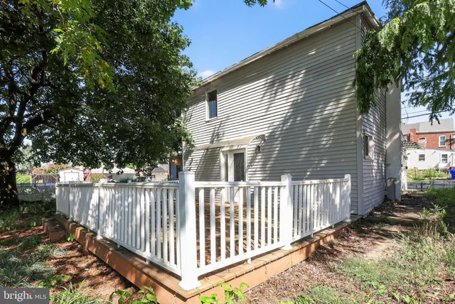 a front view of a house with wooden fence