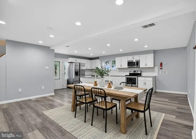 a view of a dining room with furniture and wooden floor