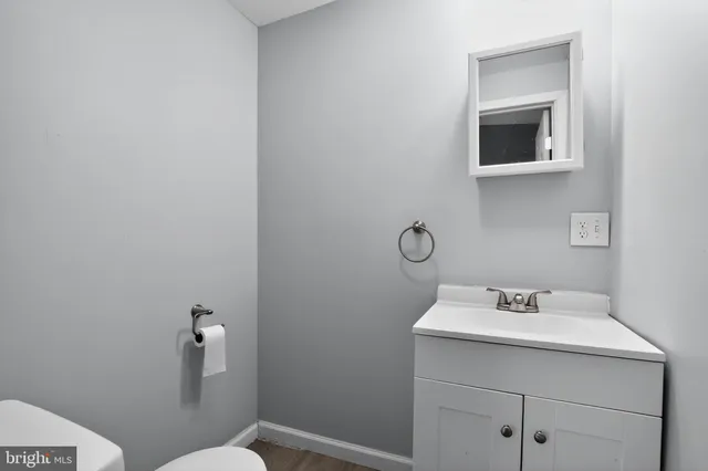 a bathroom with a toilet sink and mirror