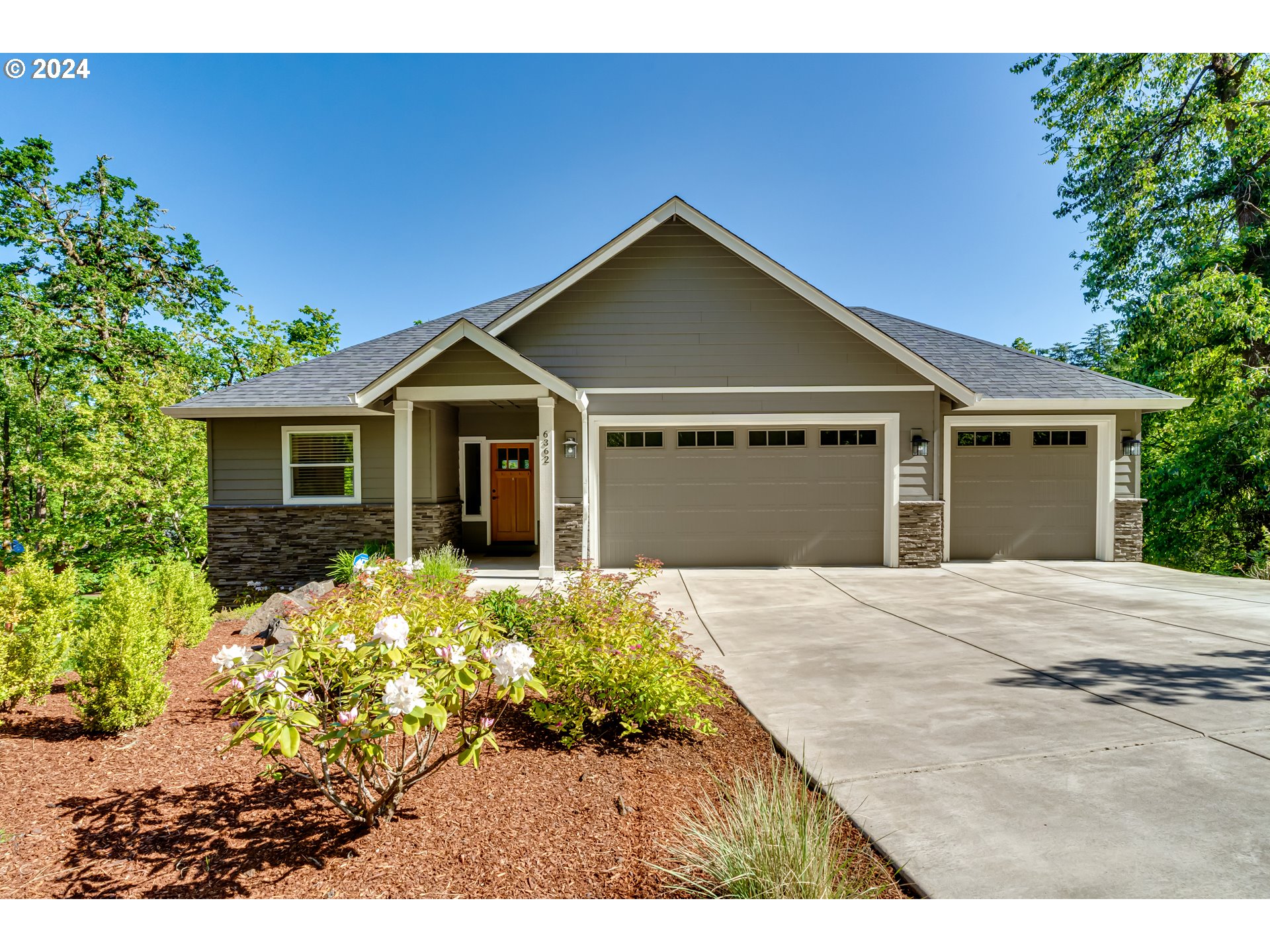 6362 Forest Ridge Drive Springfield, OR 97478 - Photo 1 of 44 a front view of a house with a garden