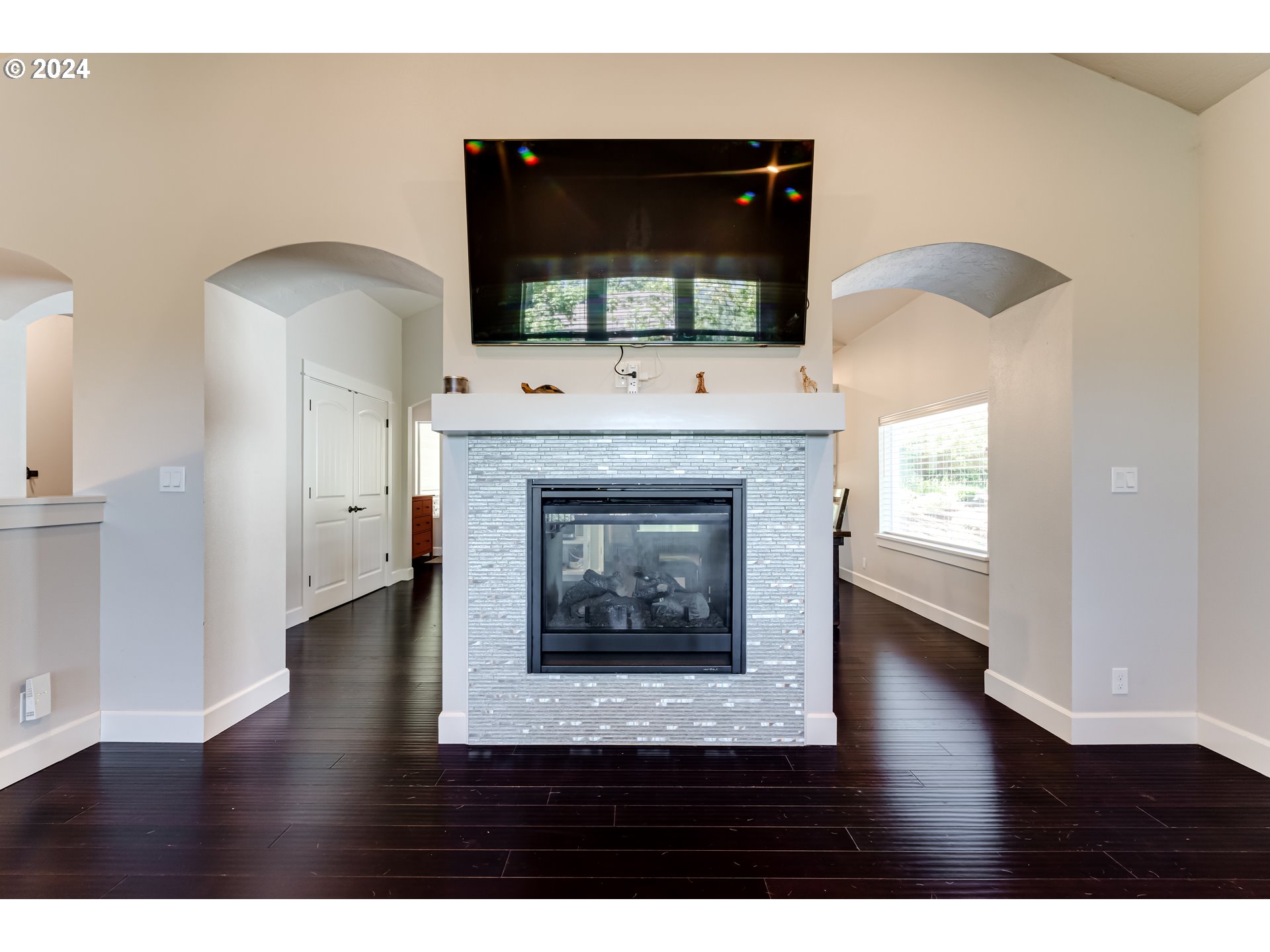 6362 Forest Ridge Drive Springfield, OR 97478 - Photo 13 of 44 a living room with a fireplace and a flat screen tv