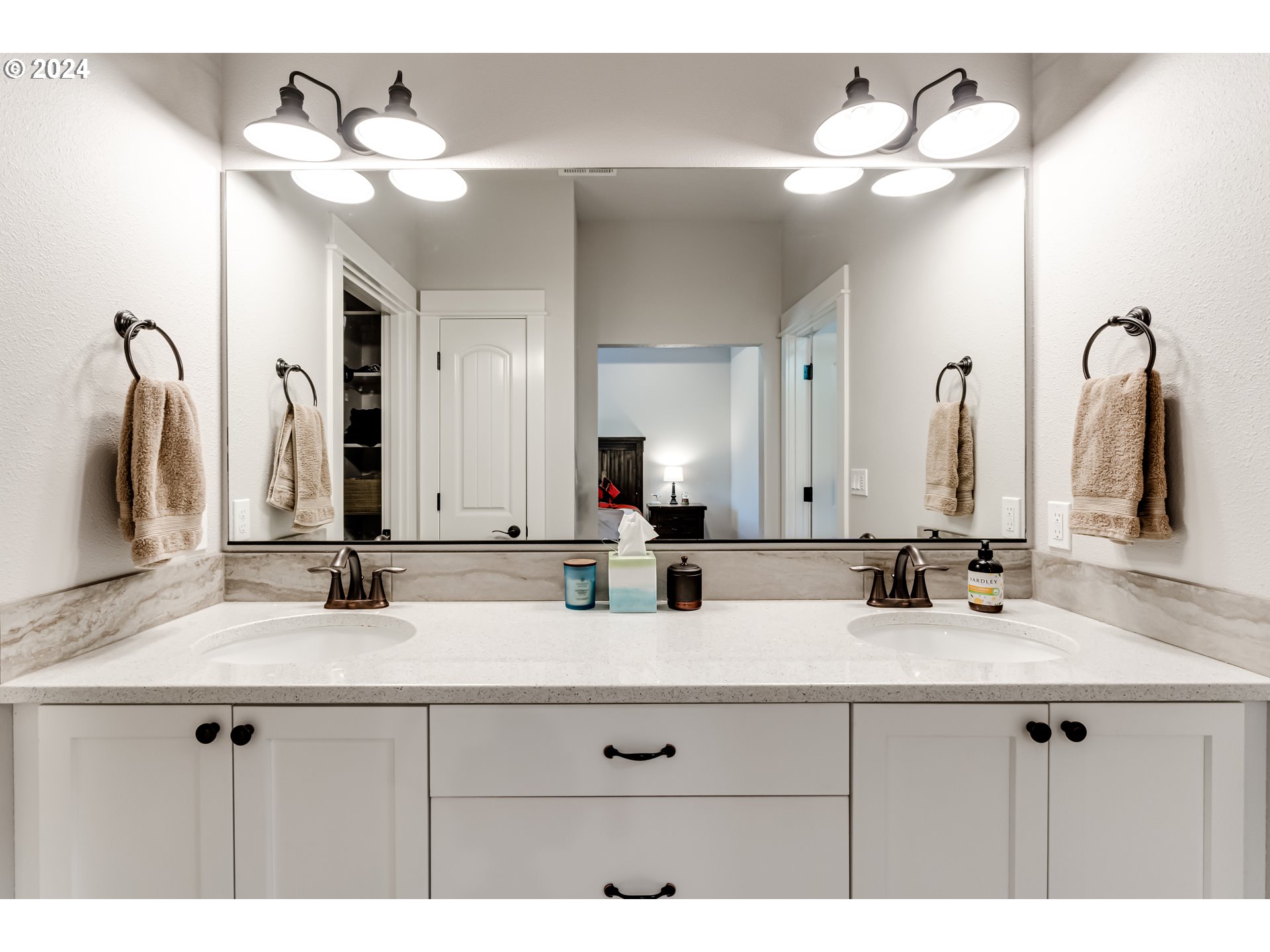 6362 Forest Ridge Drive Springfield, OR 97478 - Photo 24 of 44 a bathroom with double vanity sinks a vanity a lamp and a mirror