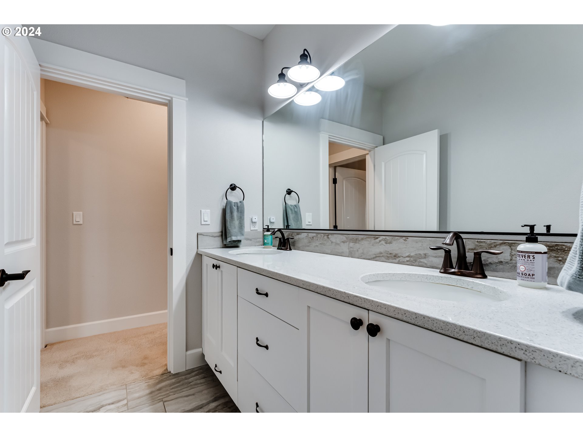 6362 Forest Ridge Drive Springfield, OR 97478 - Photo 35 of 44 a bathroom with a double vanity sink and a mirror