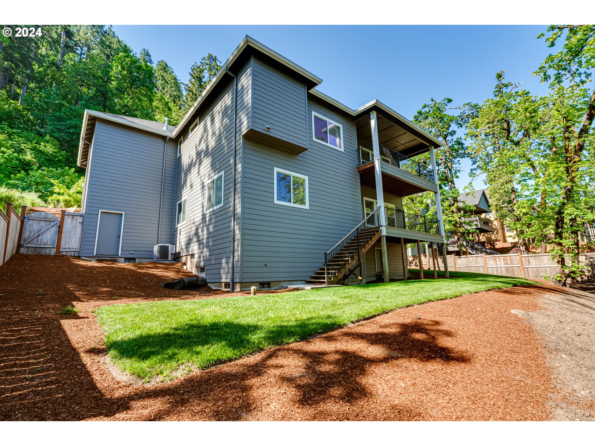6362 Forest Ridge Drive Springfield, OR 97478 - Photo 44 of 44 a front view of a house with a yard and garage