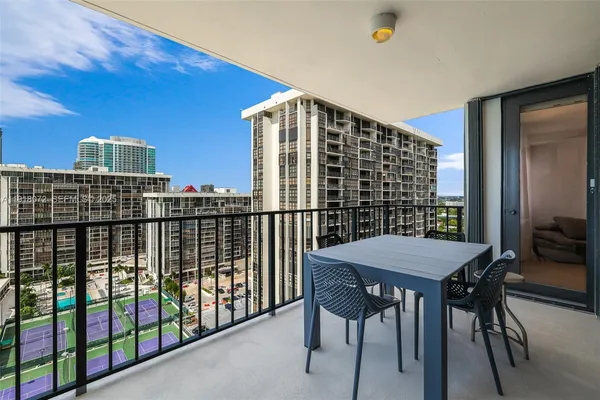 a view of a balcony dining table and chairs
