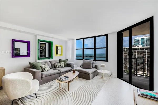 a living room with furniture and a large window