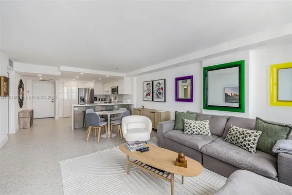 a living room with furniture and kitchen view