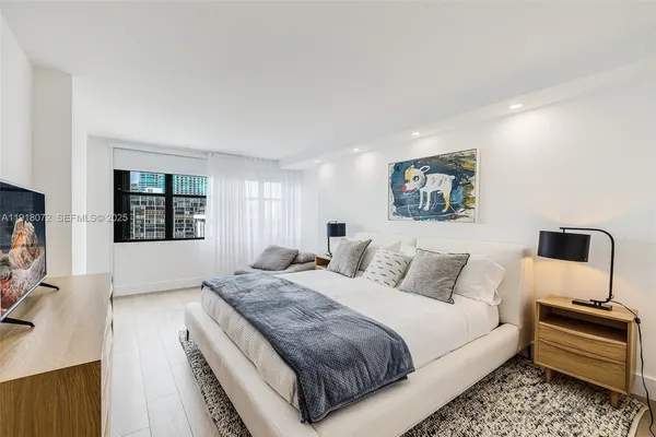 a bedroom with a large bed and a couch