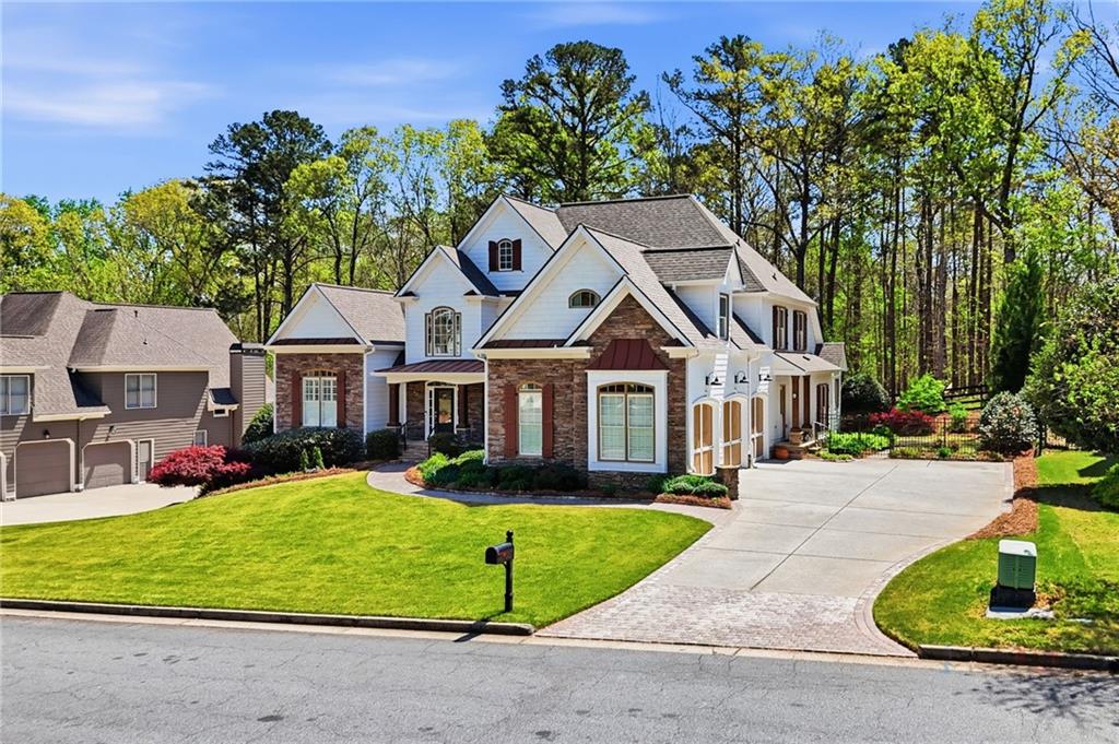 4147 Gold Mill Ridge Canton, GA 30114 - Photo 2 of 93 a front view of a house with a yard table and chairs