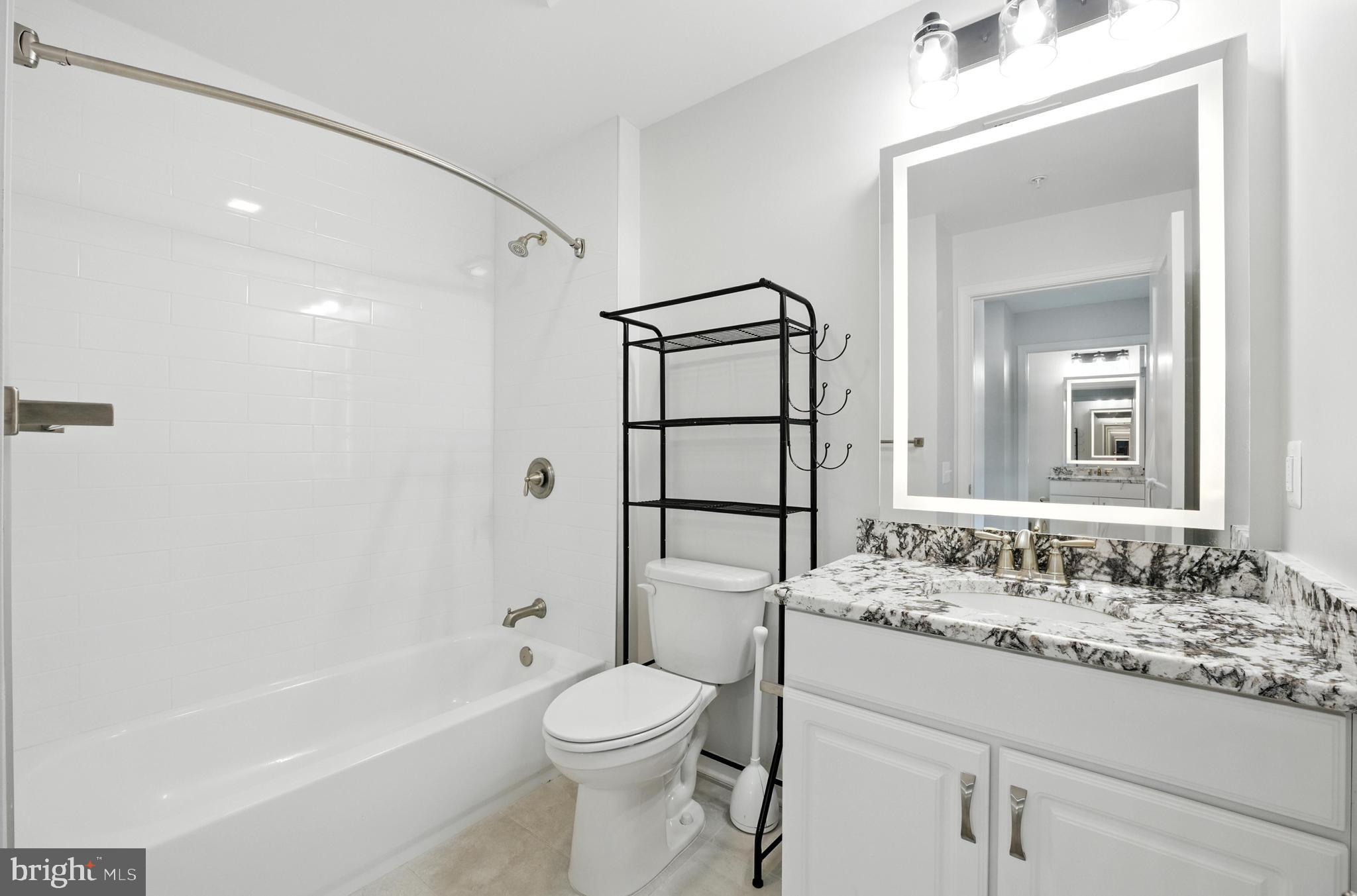 19510 Village Walk, Unit 2205 Montgomery Village, MD 20886 - Photo 20 of 21 a bathroom with a sink a toilet and shower