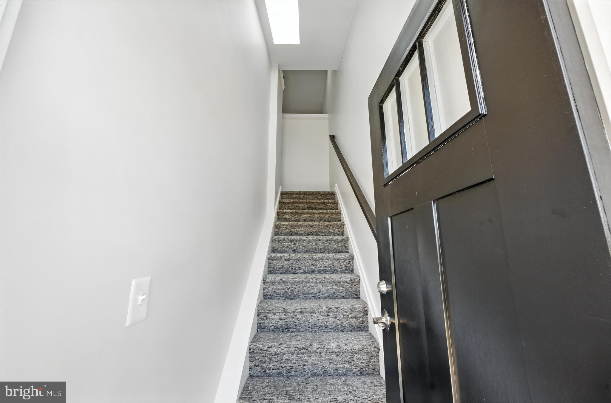 19510 Village Walk, Unit 2205 Montgomery Village, MD 20886 - Photo 4 of 21 a view of staircase with wooden floor and white walls