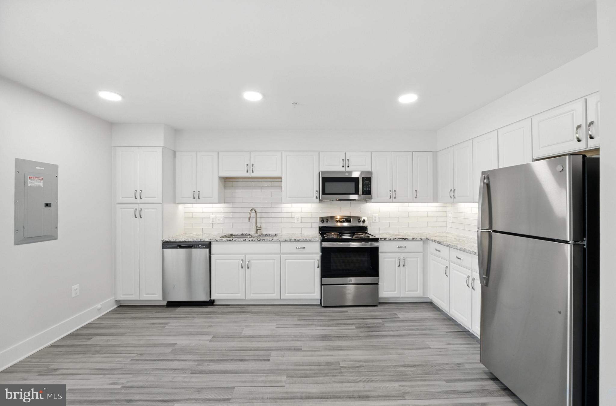 19510 Village Walk, Unit 2205 Montgomery Village, MD 20886 - Photo 6 of 21 a kitchen with stainless steel appliances a refrigerator sink and stove