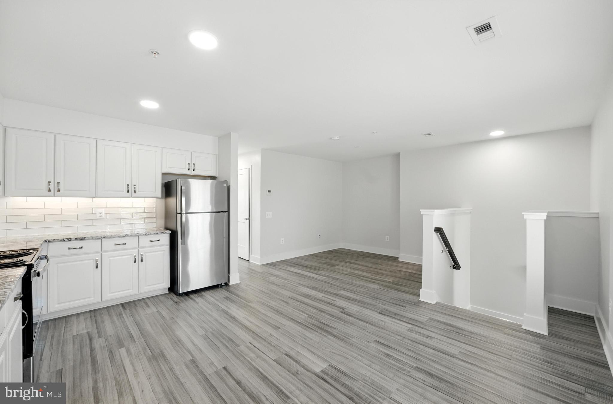 19510 Village Walk, Unit 2205 Montgomery Village, MD 20886 - Photo 8 of 21 a view of a kitchen with refrigerator and wooden floor
