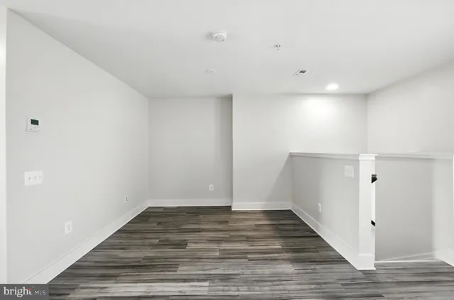 a view of room with wooden floor