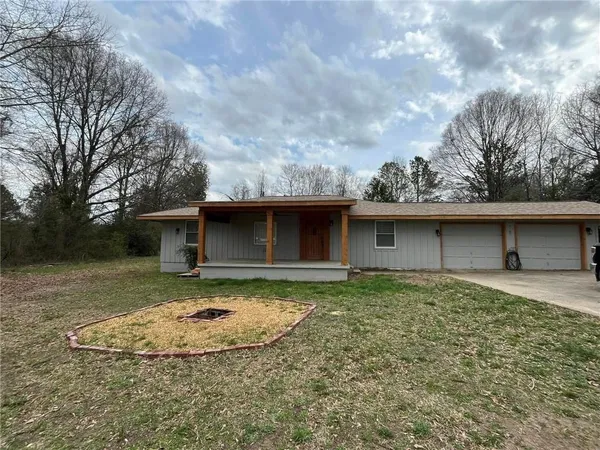 a view of a house with a yard and garage
