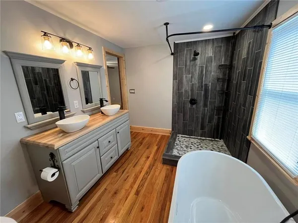 a bathroom with a sink a toilet and shower