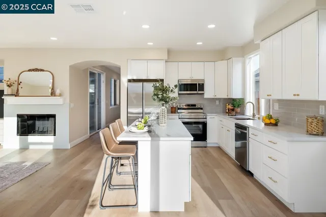 a kitchen with cabinets a sink and appliances