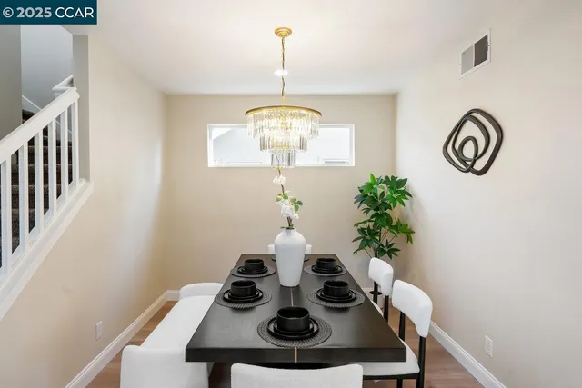 a view of a dining room with furniture and chandelier