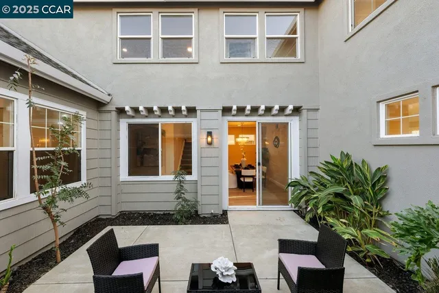 a view of house with a chairs and table in a patio