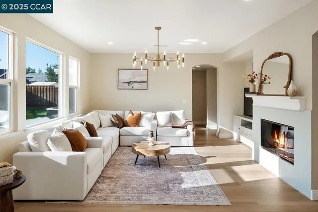a living room with furniture fireplace and window